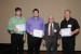 Dr. Nagib Callaos, General Chair, giving Dr. David T. Smith, Mr. Joseph Gibson, and Mr.  Mr. Thomas Taylor (co-authors and co-presenters)  the best paper award certificate of the session "Research, Education, and Teaching." The title of the awarded paper is "Educational Aspects of Undergraduate Research on Smartphone Application Development."